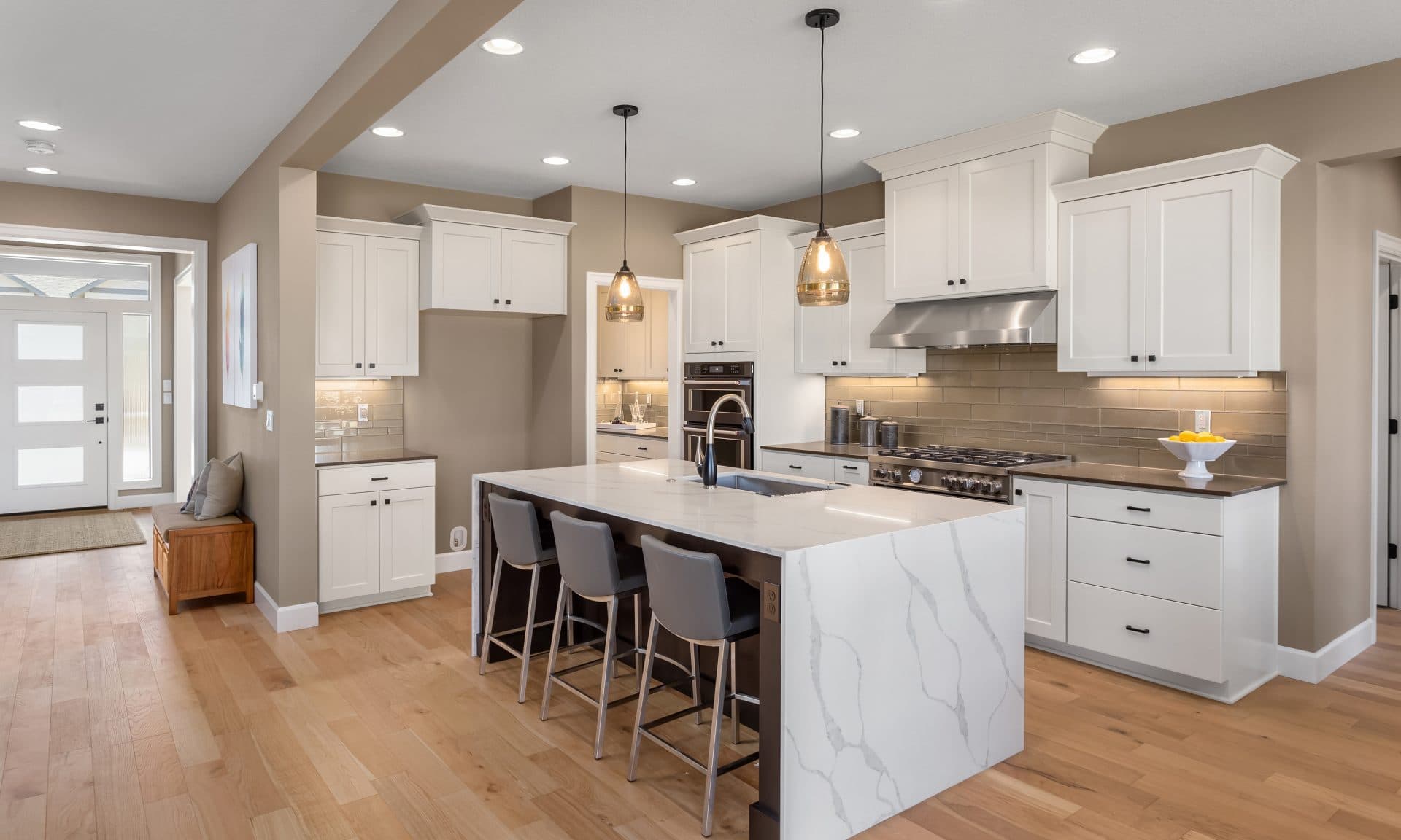 White shaker kitchen remodel with quartz waterfall island in Winter Park, FL
